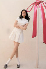 UO Bryan Bow-Back Pleated Drop Waist Denim Mini Dress